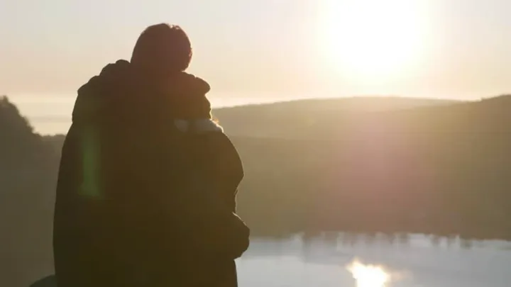 A few minutes after Mel and I got engaged — Standing together on top of the West Lake Bluff watching the sun rise.